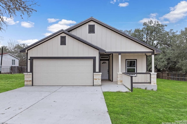 view of front of house featuring a garage, driveway, a porch, and a front lawn