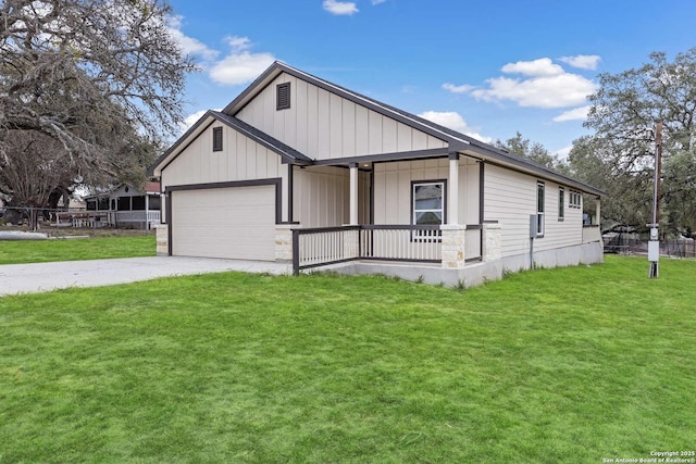 view of home's exterior with a garage, driveway, a lawn, covered porch, and board and batten siding