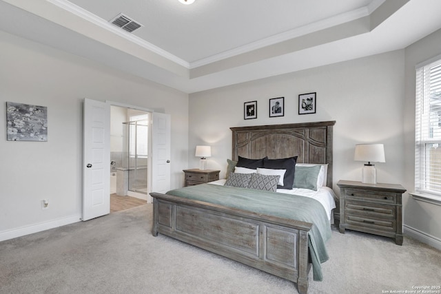 bedroom featuring light carpet, baseboards, visible vents, a tray ceiling, and crown molding