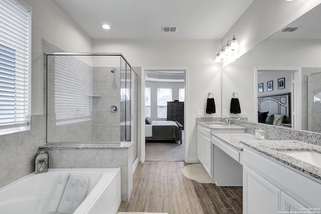 bathroom with visible vents, connected bathroom, a sink, and double vanity