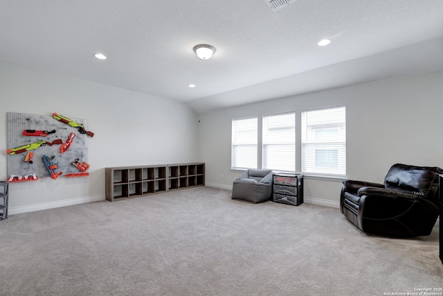 living area featuring a textured ceiling, recessed lighting, light colored carpet, baseboards, and vaulted ceiling