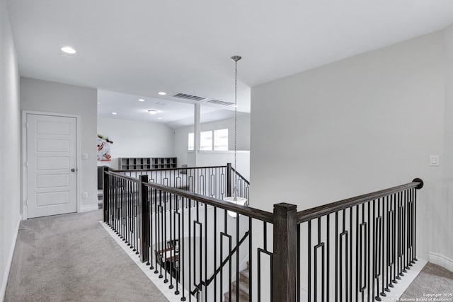 hallway featuring recessed lighting, visible vents, carpet flooring, an upstairs landing, and baseboards