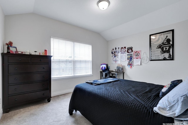 bedroom featuring baseboards, vaulted ceiling, and light colored carpet