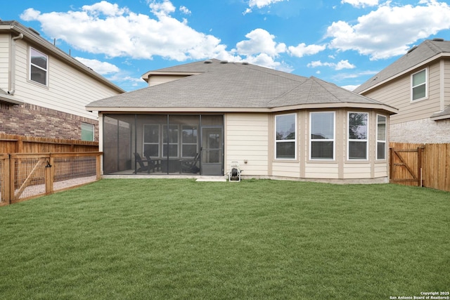 rear view of property with a shingled roof, a lawn, a sunroom, a fenced backyard, and a gate