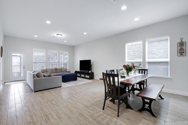 dining space featuring recessed lighting, plenty of natural light, light wood-style flooring, and baseboards