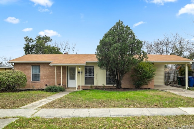 ranch-style house with a front yard and brick siding