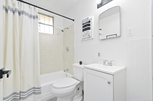 bathroom with wainscoting, vanity, toilet, and shower / tub combo with curtain