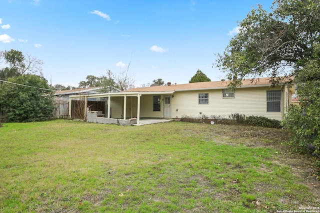 back of house featuring a patio, a lawn, and fence