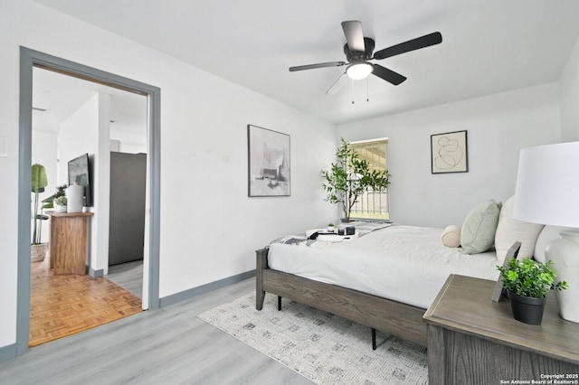 bedroom featuring parquet floors, ceiling fan, and baseboards