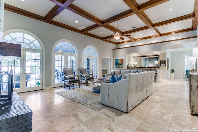 living area with beam ceiling, french doors, a high ceiling, coffered ceiling, and baseboards