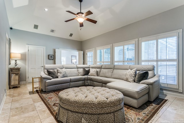 living area featuring vaulted ceiling, ceiling fan, visible vents, and baseboards