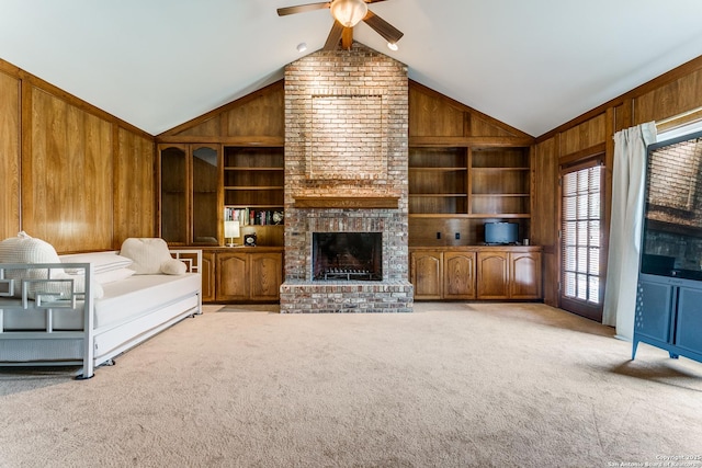 unfurnished living room featuring vaulted ceiling, built in shelves, light colored carpet, and wooden walls