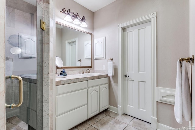 bathroom featuring an enclosed shower, vanity, and tile patterned floors