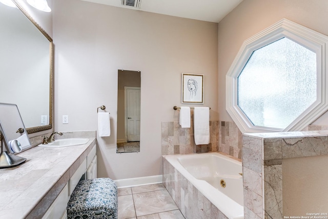 full bath with visible vents, vanity, tile patterned flooring, a jetted tub, and baseboards