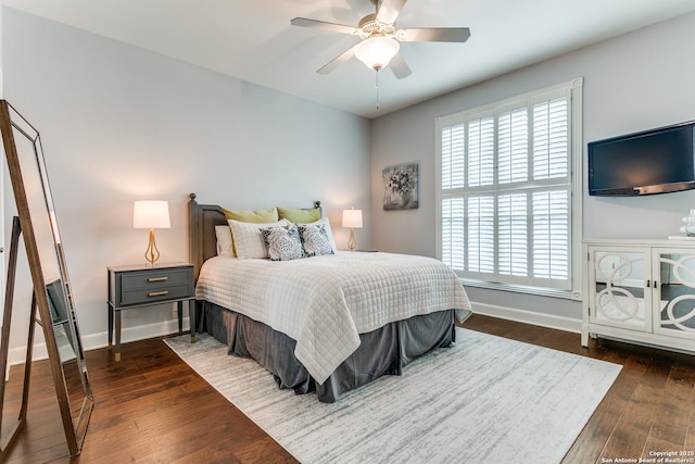 bedroom with dark wood-style flooring, ceiling fan, and baseboards