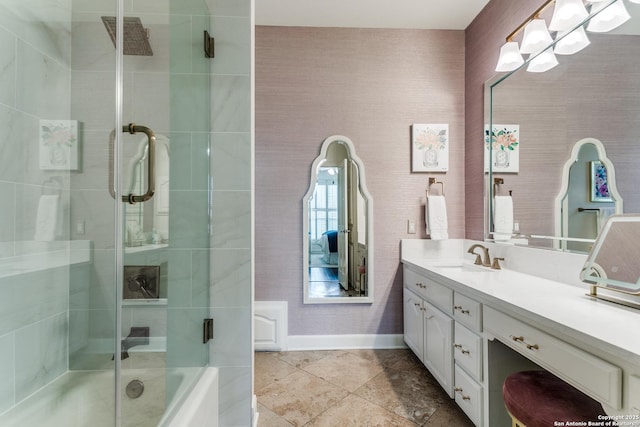 full bathroom with enclosed tub / shower combo, baseboards, and vanity