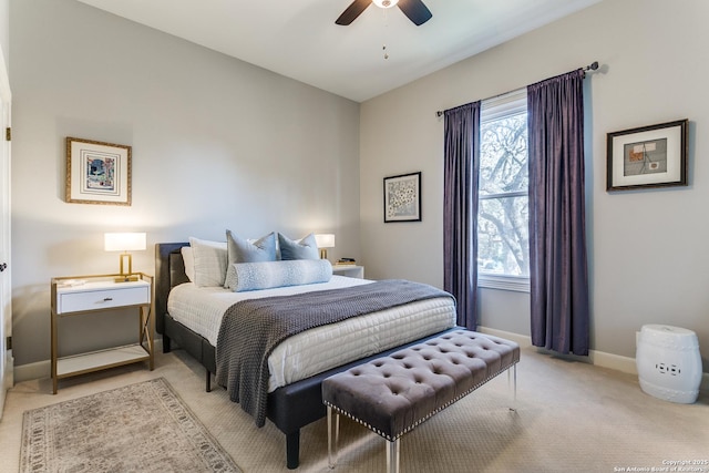 bedroom featuring baseboards, ceiling fan, multiple windows, and light colored carpet