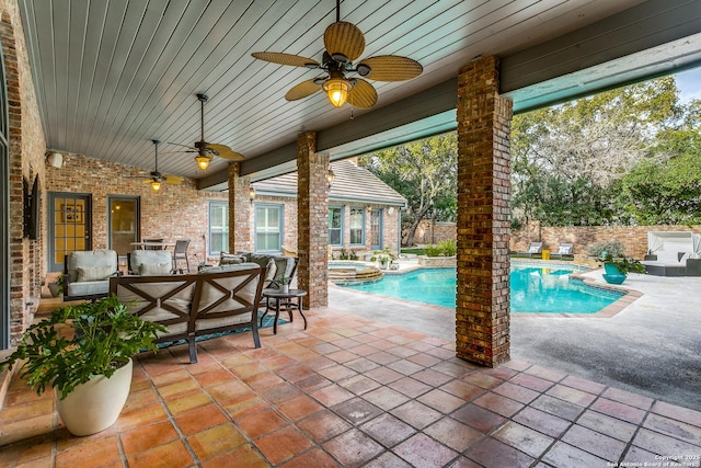 view of swimming pool with a ceiling fan, fence, a patio area, a pool with connected hot tub, and outdoor lounge area