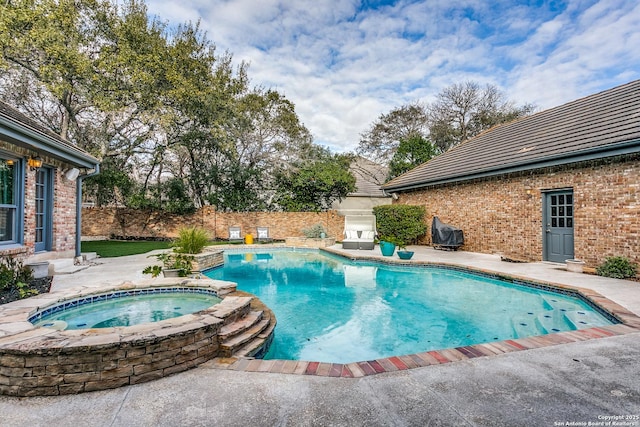 view of pool with a patio area, a fenced backyard, and a pool with connected hot tub