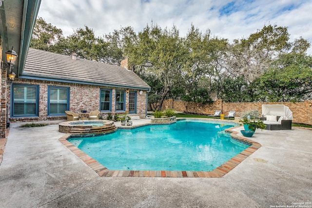 view of swimming pool featuring fence private yard, a pool with connected hot tub, and a patio