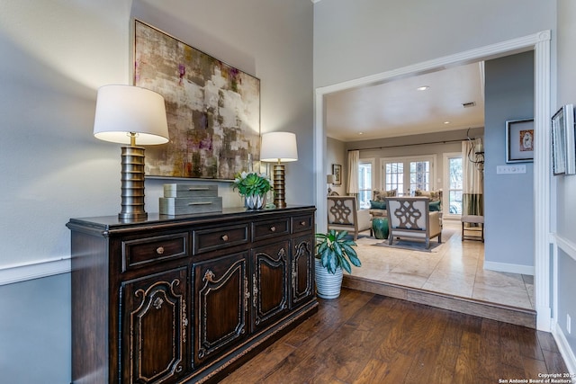 hallway featuring baseboards and wood finished floors