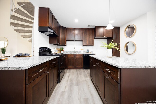 kitchen featuring under cabinet range hood, visible vents, dark brown cabinets, light countertops, and black appliances