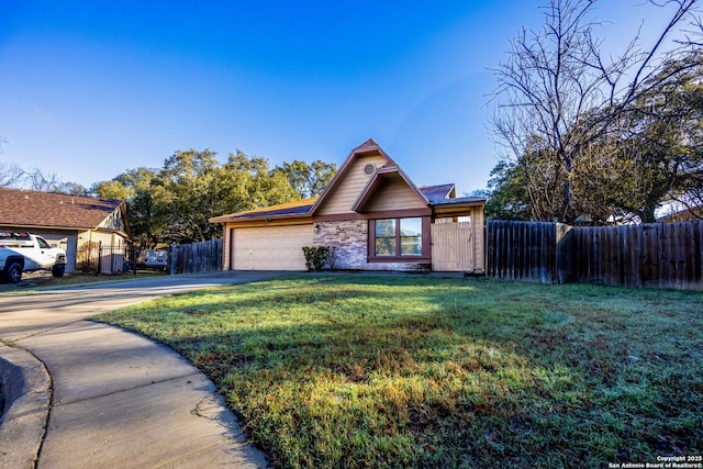 view of front of property featuring a garage, driveway, a front yard, and fence