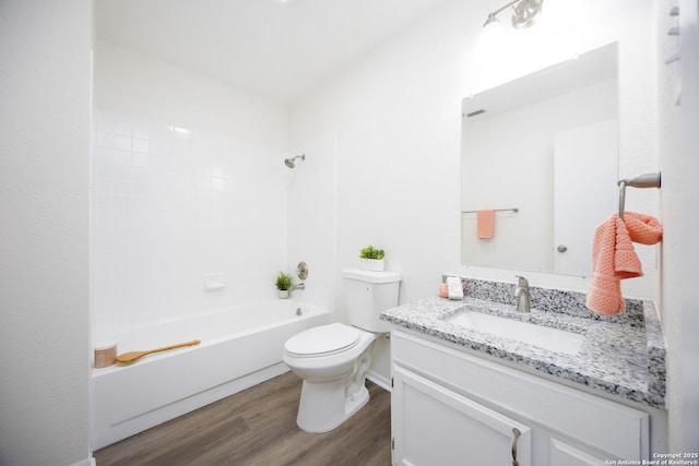 bathroom with toilet, shower / tub combination, wood finished floors, and vanity