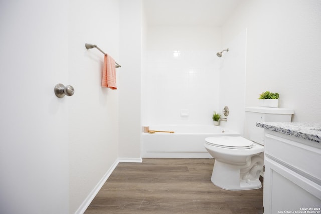 full bathroom featuring baseboards, toilet, wood finished floors, vanity, and washtub / shower combination