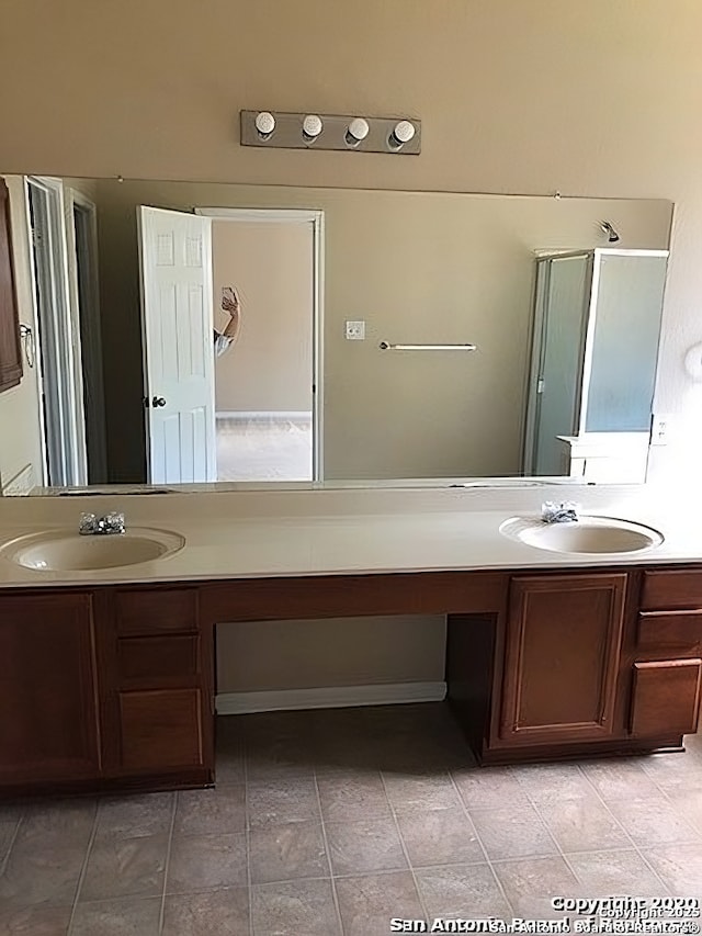 full bath with a sink and double vanity