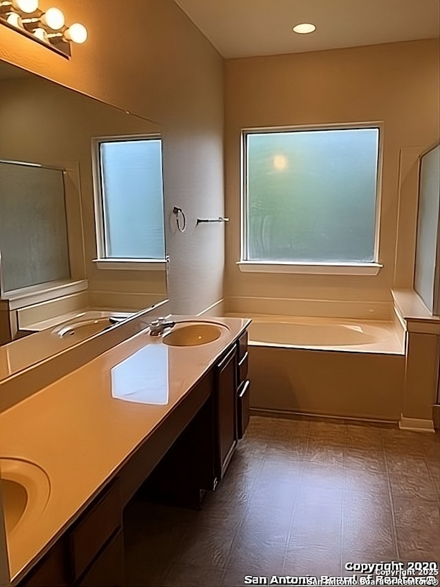 bathroom featuring double vanity, a sink, a shower stall, and a bath