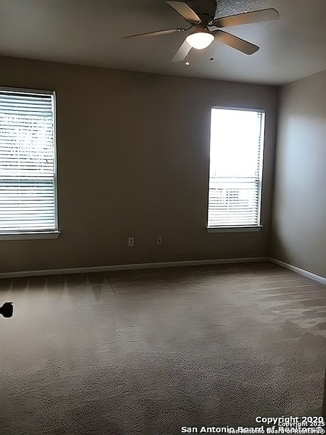 unfurnished room with a ceiling fan, baseboards, and carpet flooring