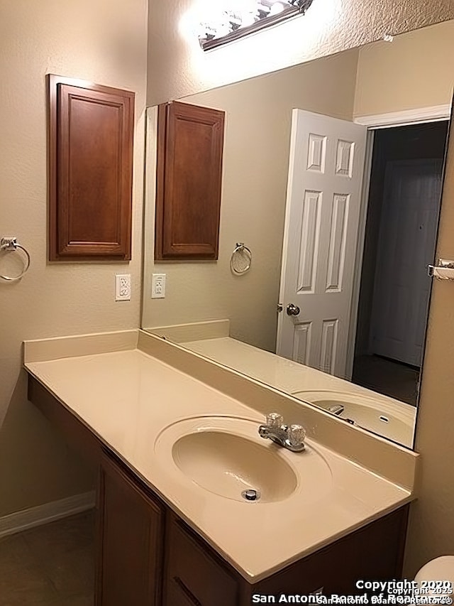 bathroom featuring vanity and baseboards