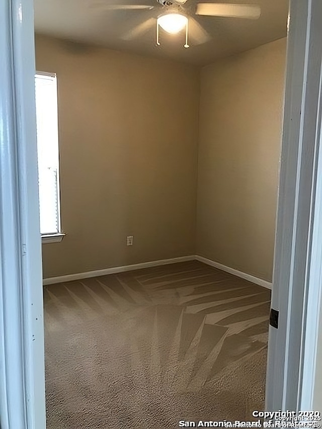 unfurnished room featuring a ceiling fan, carpet, and baseboards