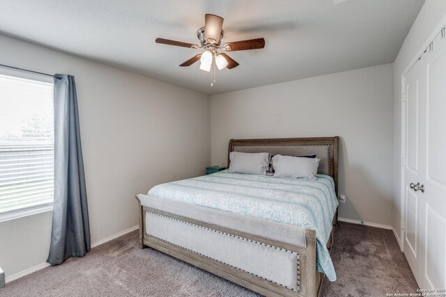 bedroom with light carpet, baseboards, and multiple windows