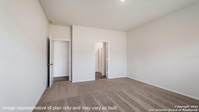 unfurnished bedroom featuring carpet and baseboards