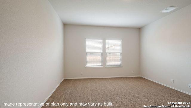 unfurnished room with baseboards and carpet flooring