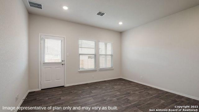 interior space with dark wood-type flooring, recessed lighting, visible vents, and baseboards