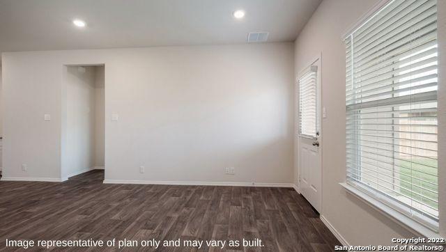 empty room featuring dark wood-style floors, recessed lighting, and baseboards