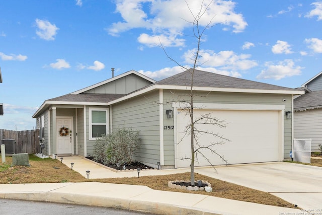 12912 Liam Ct, Saint Hedwig, TX 78152 - single story home with an attached garage, central air condition unit, fence, concrete driveway, and board and batten siding