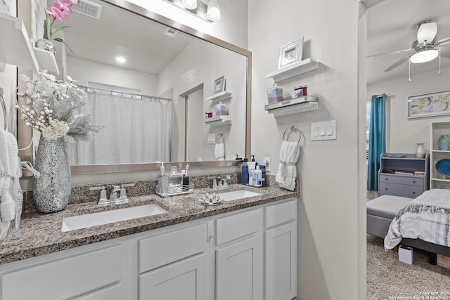 bathroom with a ceiling fan, visible vents, a sink, and double vanity