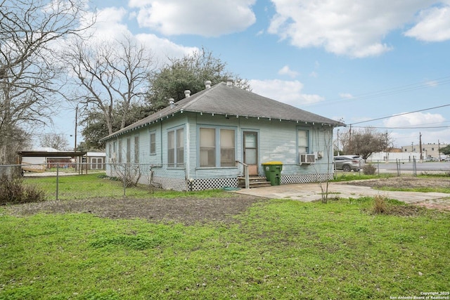 view of property exterior with entry steps, a yard, and fence