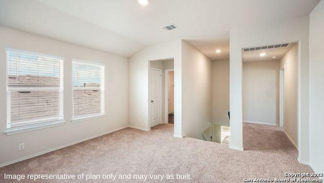 unfurnished bedroom featuring light carpet, vaulted ceiling, visible vents, and recessed lighting