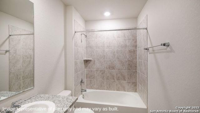 bathroom with shower / washtub combination, vanity, and toilet