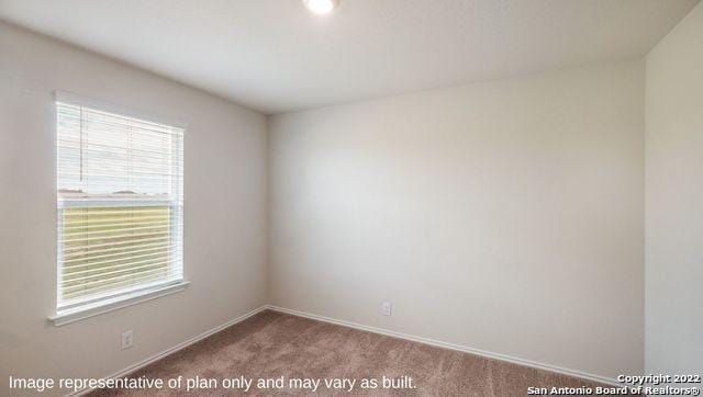 empty room featuring baseboards and light colored carpet