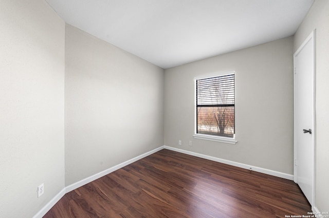 unfurnished bedroom with dark wood finished floors and baseboards