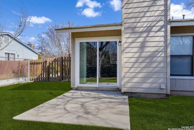 exterior space with board and batten siding, a patio area, fence, and a lawn