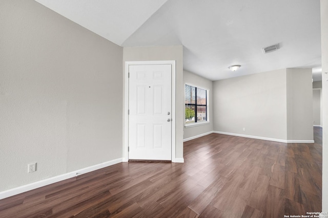 unfurnished room with baseboards, visible vents, and dark wood finished floors