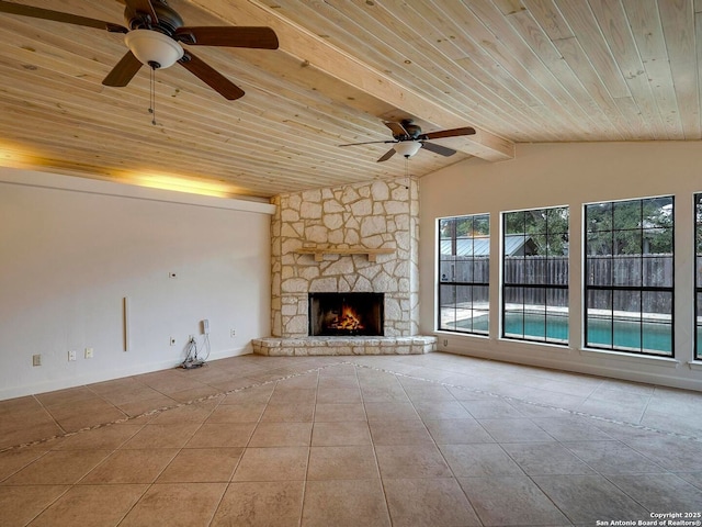 unfurnished living room with vaulted ceiling with beams, a fireplace, light tile patterned floors, a ceiling fan, and wooden ceiling