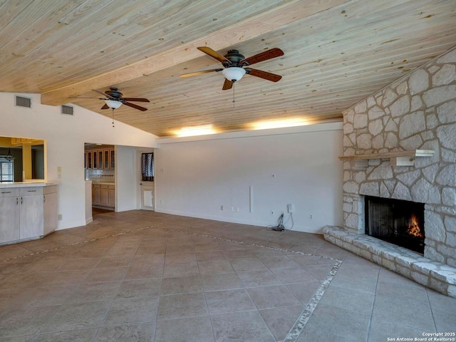 unfurnished living room featuring vaulted ceiling with beams, wood ceiling, visible vents, and a stone fireplace